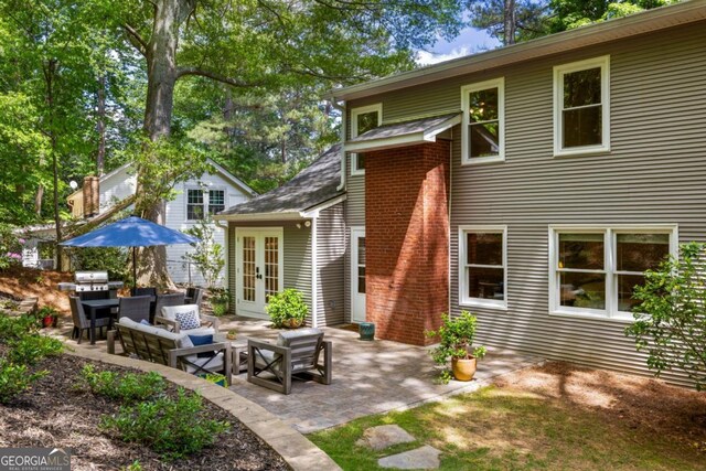 rear view of house featuring french doors, a patio area, and an outdoor hangout area