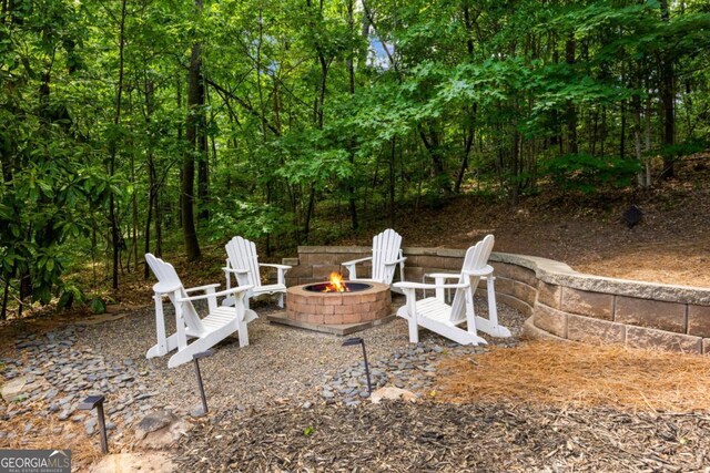 view of yard with an outdoor fire pit