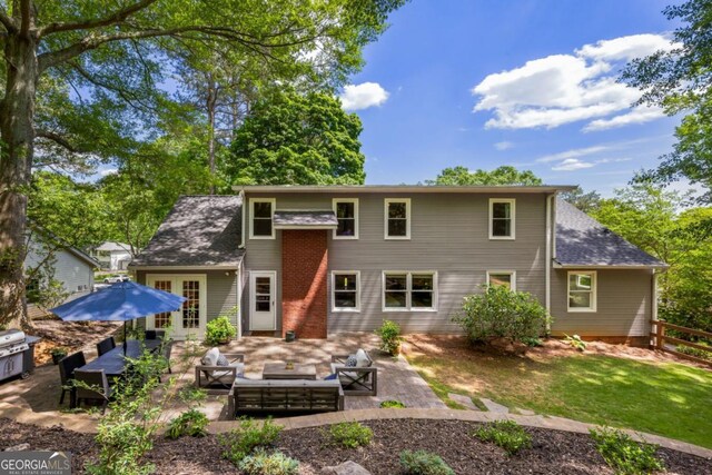 rear view of property featuring an outdoor living space, a patio area, and fence
