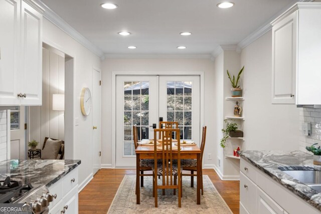 dining room featuring wood finished floors, crown molding, french doors, recessed lighting, and baseboards