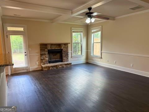 1307 Clarecastle Ln, Buford, GA 30519 - kitchen with stainless steel appliances, light countertops, crown molding, backsplash, and light wood-style flooring