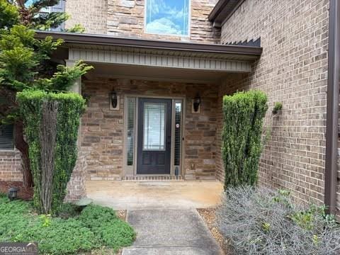 1307 Clarecastle Ln, Buford, GA 30519 - view of exterior entry featuring brick siding