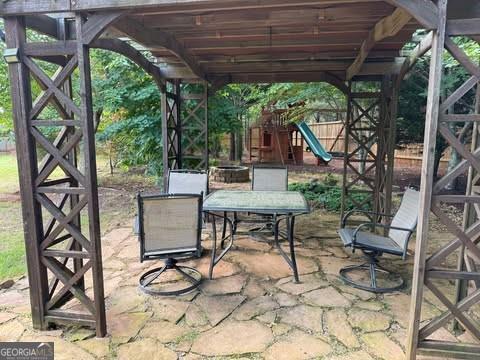 1307 Clarecastle Ln, Buford, GA 30519 - view of patio with a playground