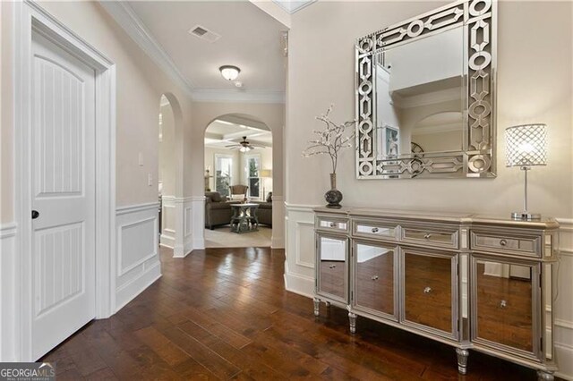 1307 Clarecastle Ln, Buford, GA 30519 - foyer featuring ornamental molding, dark wood-type flooring, a decorative wall, and wainscoting