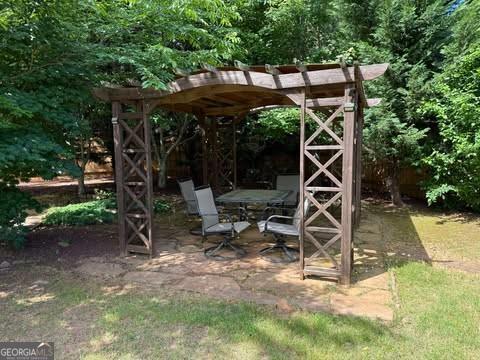 1307 Clarecastle Ln, Buford, GA 30519 - view of patio featuring a forest view
