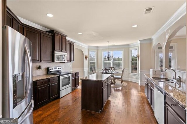 1307 Clarecastle Ln, Buford, GA 30519 - living room with crown molding, a ceiling fan, wood finished floors, stairway, and recessed lighting