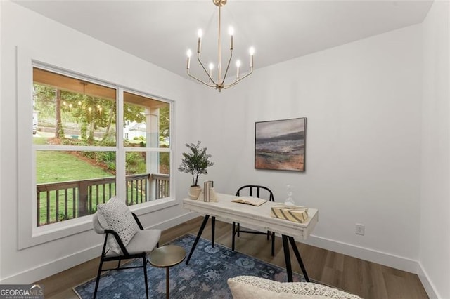 office area featuring healthy amount of natural light, baseboards, a chandelier, and dark wood-type flooring