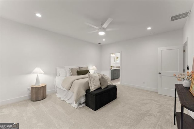 bedroom featuring light carpet, recessed lighting, baseboards, and ensuite bath