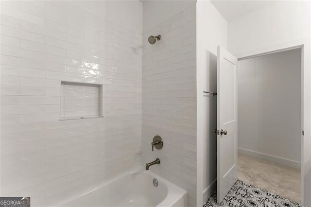 bathroom with shower / bath combination and baseboards