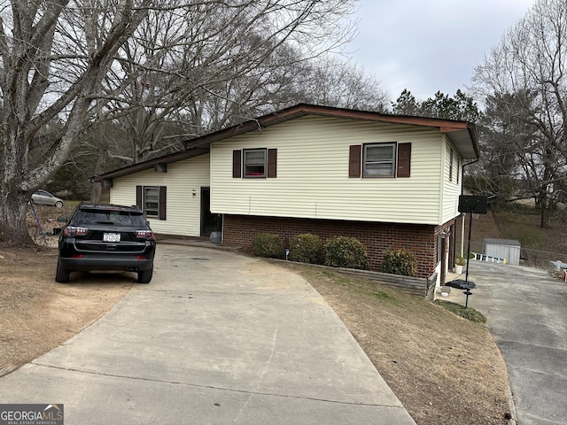 split level home featuring concrete driveway