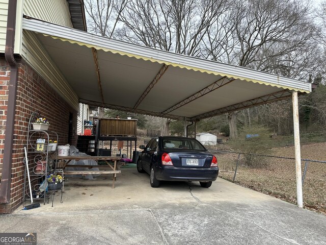2195 Wilson Rd NW, Conyers, GA 30012 - view of parking featuring fence and an attached carport