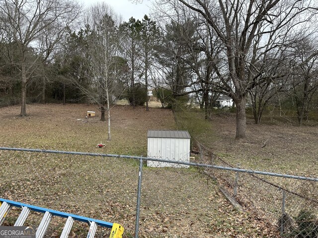2195 Wilson Rd NW, Conyers, GA 30012 - view of yard with a storage unit, an outdoor structure, and fence