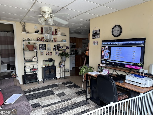 office with a ceiling fan, a drop ceiling, and carpet floors