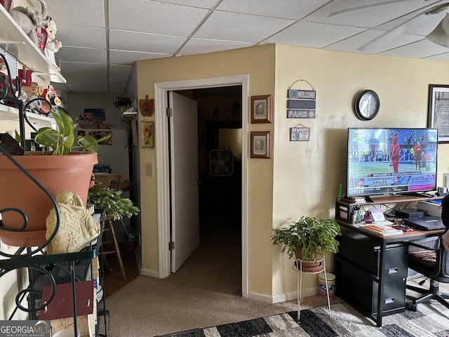 office featuring a drop ceiling, carpet, and baseboards