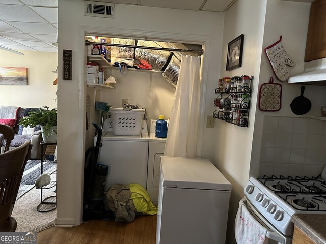 2195 Wilson Rd NW, Conyers, GA 30012 - laundry room with washing machine and clothes dryer and wood finished floors