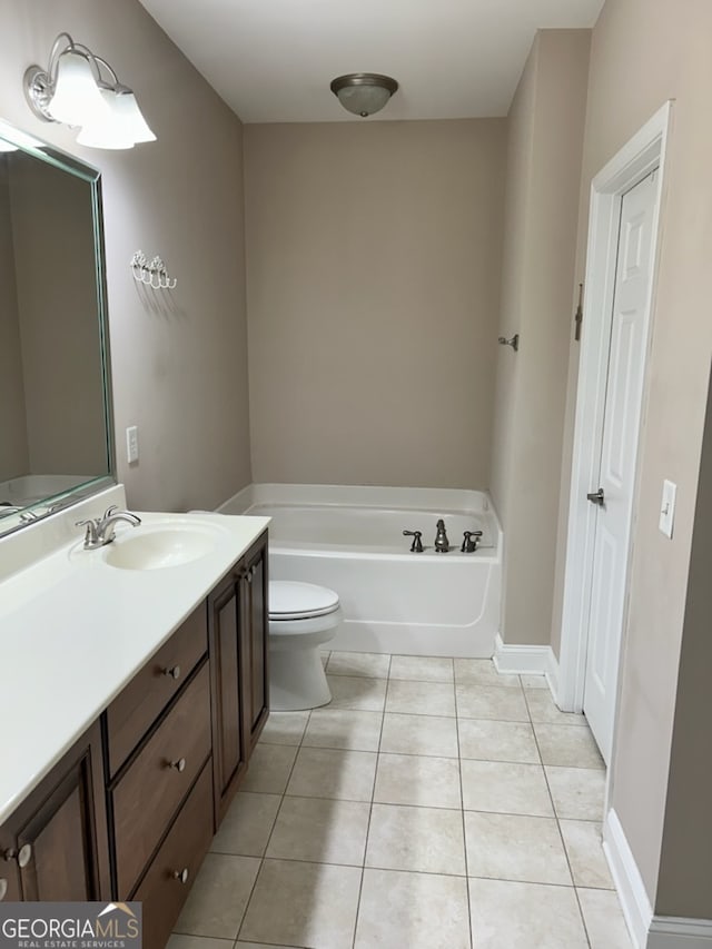 bathroom featuring vanity, a garden tub, tile patterned flooring, and toilet