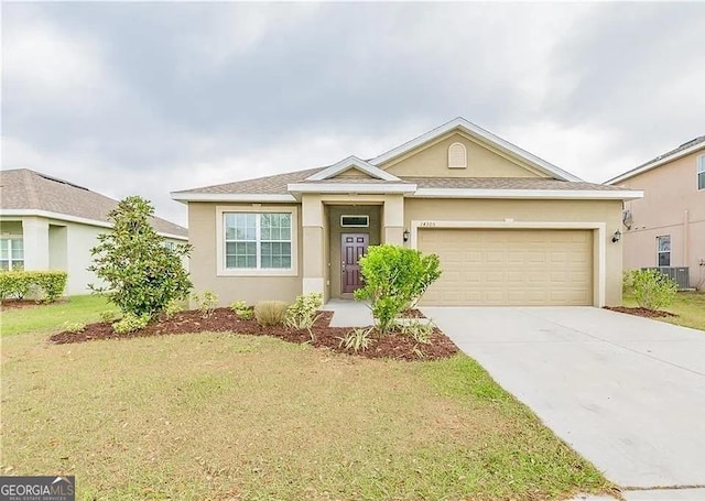 ranch-style house with a garage, concrete driveway, stucco siding, and a front lawn