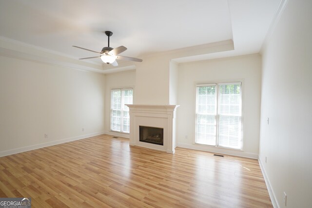 936 Bramble Oak Ct, Powder Springs, GA 30127 - unfurnished living room with a fireplace, a ceiling fan, light wood finished floors, ornamental molding, and baseboards