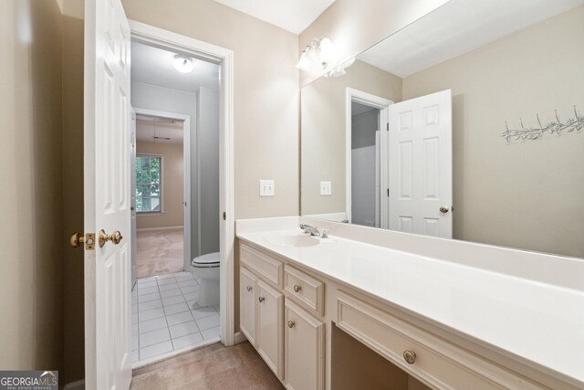 936 Bramble Oak Ct, Powder Springs, GA 30127 - bathroom featuring toilet, vanity, and tile patterned flooring