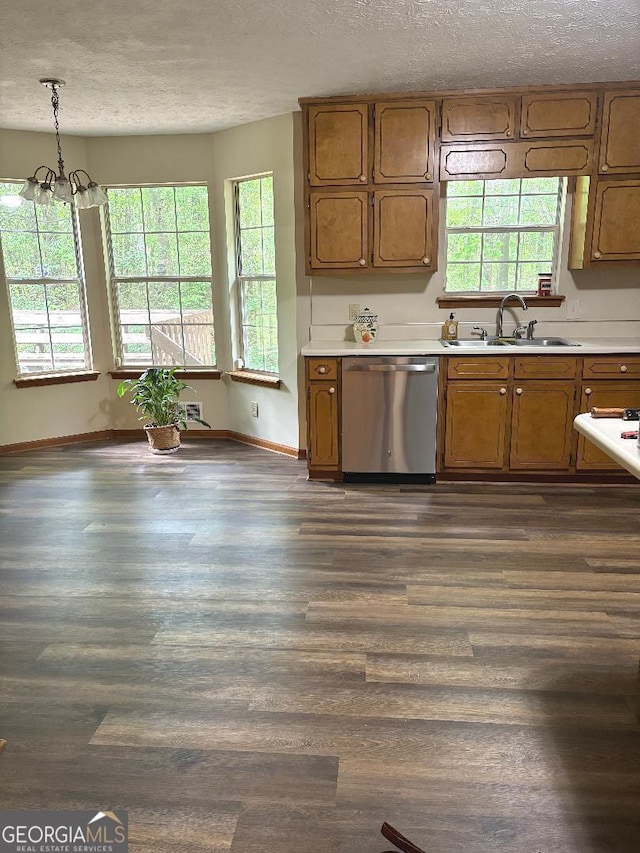 305 Glenloch Ln, Stockbridge, GA 30281 - kitchen with dishwasher, a sink, a textured ceiling, light countertops, and brown cabinetry