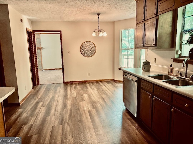 305 Glenloch Ln, Stockbridge, GA 30281 - kitchen with stainless steel dishwasher, a sink, dark wood-style flooring, light countertops, and a textured ceiling
