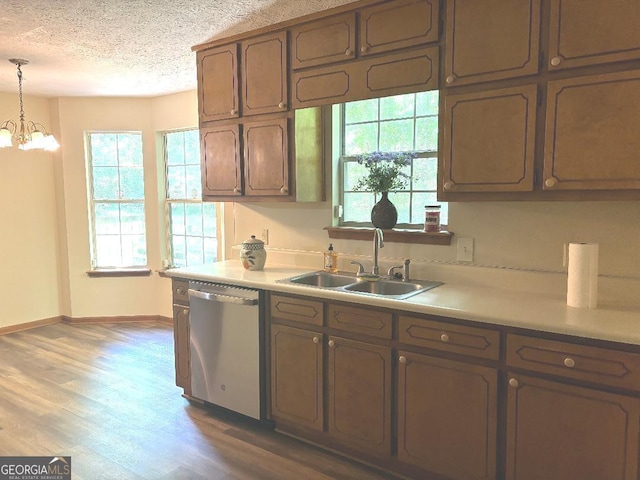 305 Glenloch Ln, Stockbridge, GA 30281 - kitchen with stainless steel dishwasher, a sink, a textured ceiling, light countertops, and baseboards