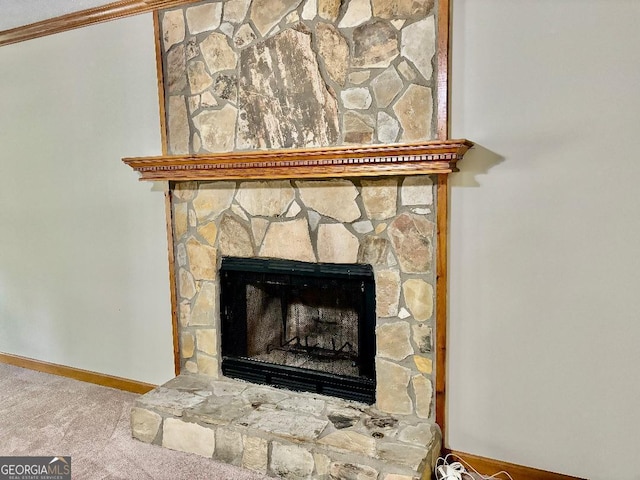 305 Glenloch Ln, Stockbridge, GA 30281 - detailed view of carpet, baseboards, a stone fireplace, and crown molding
