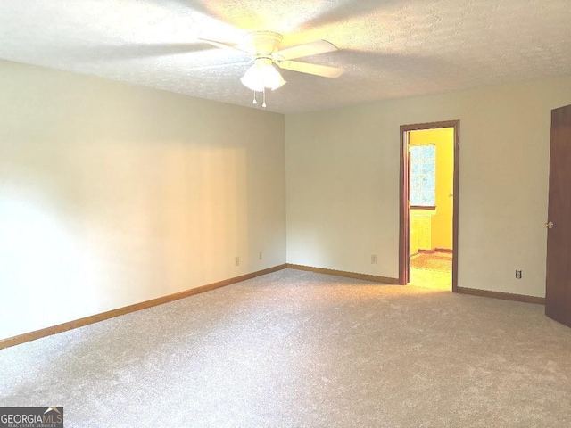 305 Glenloch Ln, Stockbridge, GA 30281 - empty room featuring light carpet, ceiling fan, baseboards, and a textured ceiling