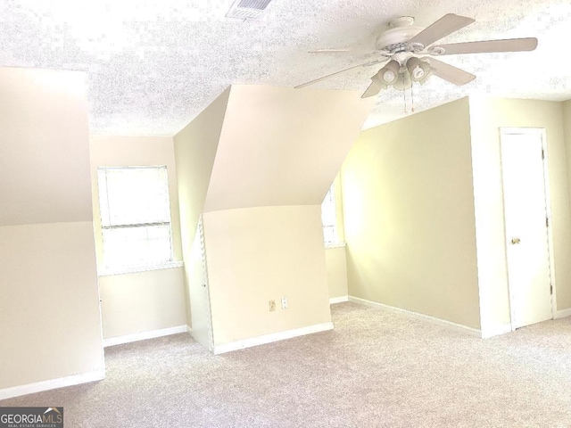 305 Glenloch Ln, Stockbridge, GA 30281 - additional living space featuring a ceiling fan, carpet, baseboards, a textured ceiling, and lofted ceiling