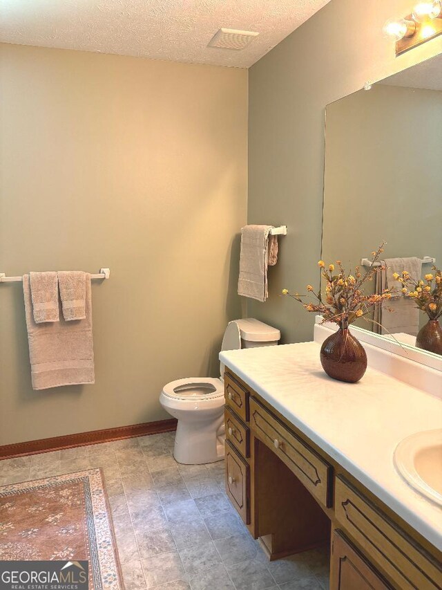 305 Glenloch Ln, Stockbridge, GA 30281 - bathroom with vanity, toilet, and a textured ceiling