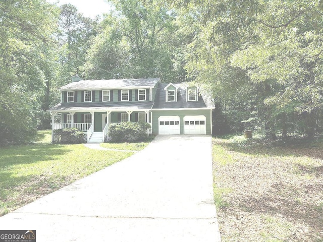 305 Glenloch Ln, Stockbridge, GA 30281 - colonial inspired home featuring a porch, concrete driveway, a front lawn, and an attached garage
