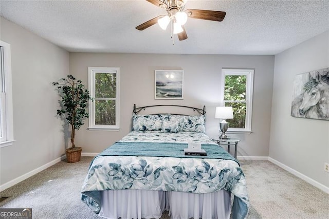 10213 Tall Pine Ct, Villa Rica, GA 30180 - bedroom featuring carpet flooring, multiple windows, a textured ceiling, a ceiling fan, and baseboards