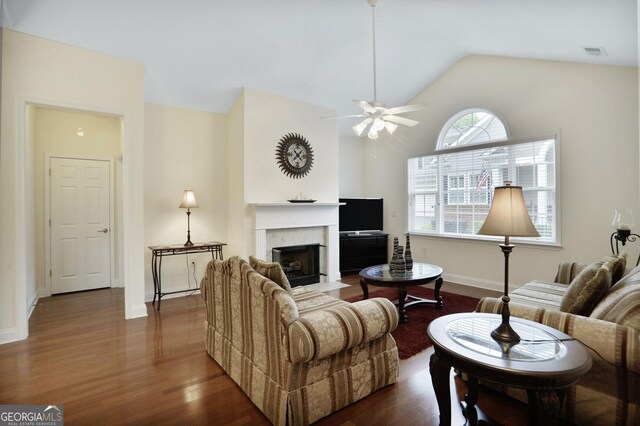 2595 Grapevine Cir, Cumming, GA 30041 - living room with a tile fireplace, ceiling fan, lofted ceiling, dark wood finished floors, and baseboards