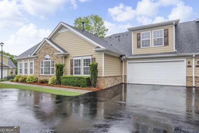 2595 Grapevine Cir, Cumming, GA 30041 - view of front of property featuring brick siding, driveway, a shingled roof, and an attached garage