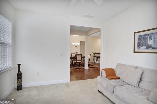 2595 Grapevine Cir, Cumming, GA 30041 - living area featuring a chandelier, carpet flooring, a ceiling fan, and baseboards
