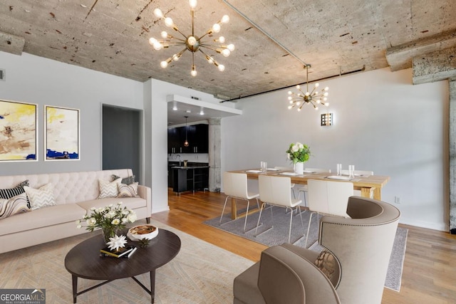 890 Memorial Dr SE Unit 105, Atlanta, GA 30316 - living area featuring a chandelier, wood finished floors, and ornate columns