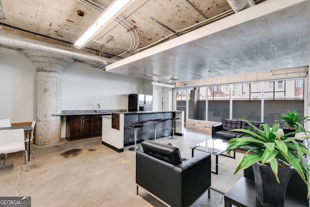 890 Memorial Dr SE Unit 105, Atlanta, GA 30316 - living room with concrete floors, a community bar, plenty of natural light, and ornate columns