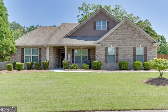 view of front of property featuring brick siding and a shingled roof