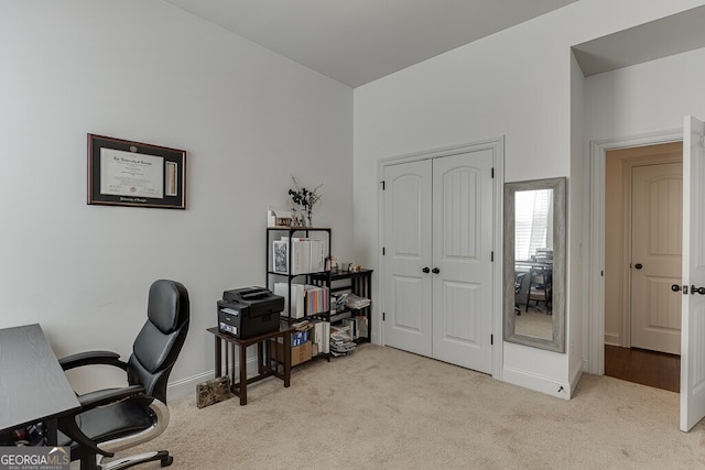 office area with light carpet and baseboards