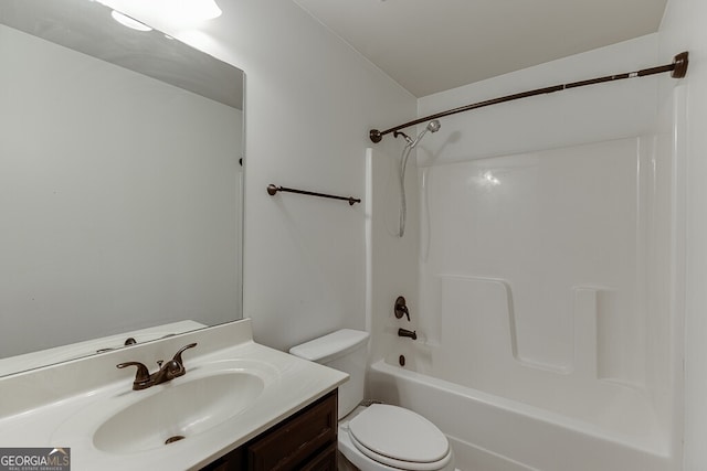 bathroom featuring toilet, vanity, and  shower combination