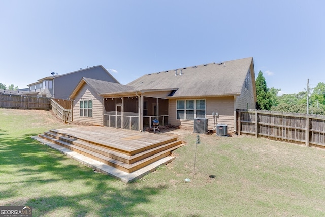 rear view of house with a sunroom, a deck, cooling unit, and a shingled roof