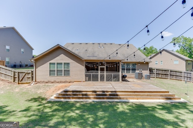 rear view of house featuring a sunroom, central AC unit, and a deck
