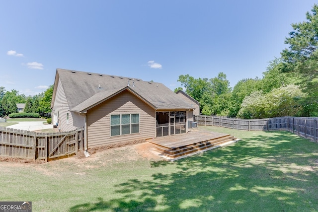 back of house with a deck, a sunroom, and roof with shingles