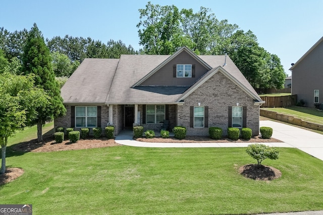 view of front of house featuring brick siding and a shingled roof