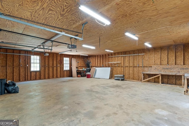 garage with a workshop area and a garage door opener