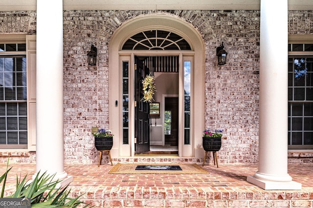 200 N Willow Ct, Alpharetta, GA 30004 - doorway to property featuring brick siding and covered porch