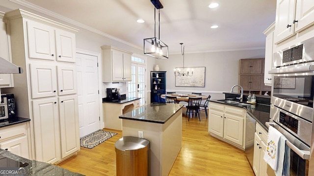200 N Willow Ct, Alpharetta, GA 30004 - kitchen with ornamental molding, recessed lighting, light wood-type flooring, appliances with stainless steel finishes, and hanging light fixtures