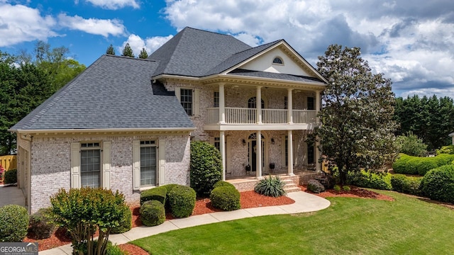 200 N Willow Ct, Alpharetta, GA 30004 - neoclassical home with a balcony, roof with shingles, a front lawn, a porch, and brick siding