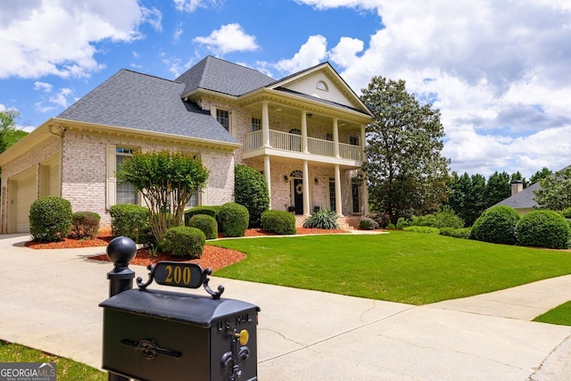 200 N Willow Ct, Alpharetta, GA 30004 - neoclassical / greek revival house with a balcony, brick siding, a front yard, and a shingled roof