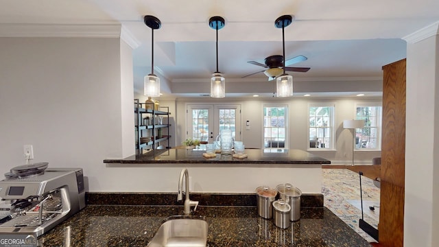 200 N Willow Ct, Alpharetta, GA 30004 - kitchen featuring ornamental molding, ceiling fan, dark stone countertops, a peninsula, and hanging light fixtures